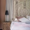 legant Queen Moroccan Headboard with a detailed carved pattern, serving as a breathtaking bedroom backdrop, enhances the room's exotic charm and sophistication.