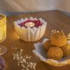 Cozy ambiance with Natural Handicrafts' Hover Petal Candle Floater, lit candle amidst rose petals, paired with golden laddus, enhancing the warm glow of a tranquil evening.