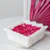 White Hover Square Candle Floater filled with striking pink rose petals beside a vibrant pink fan, creating a soothing and stylish atmosphere in any room.