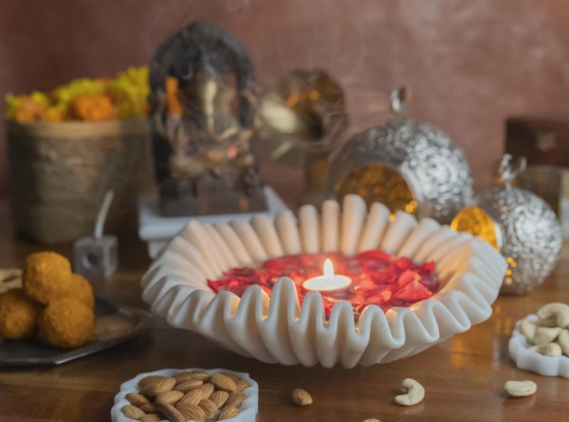 Handcrafted white marble bowl designed as a candle floater, set amidst festive decor, ideal for serene home ambiance.