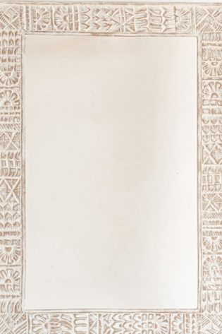 Exquisitely handcrafted carved wood mirror frame with tribal designs in a whitewash finish, ready to complement your nature-inspired home decor.