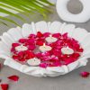 Natural Handicrafts' Calm Candle Floater with delicate flower design, adorned with vibrant rose petals and lit tea candles, creating a peaceful and romantic atmosphere.