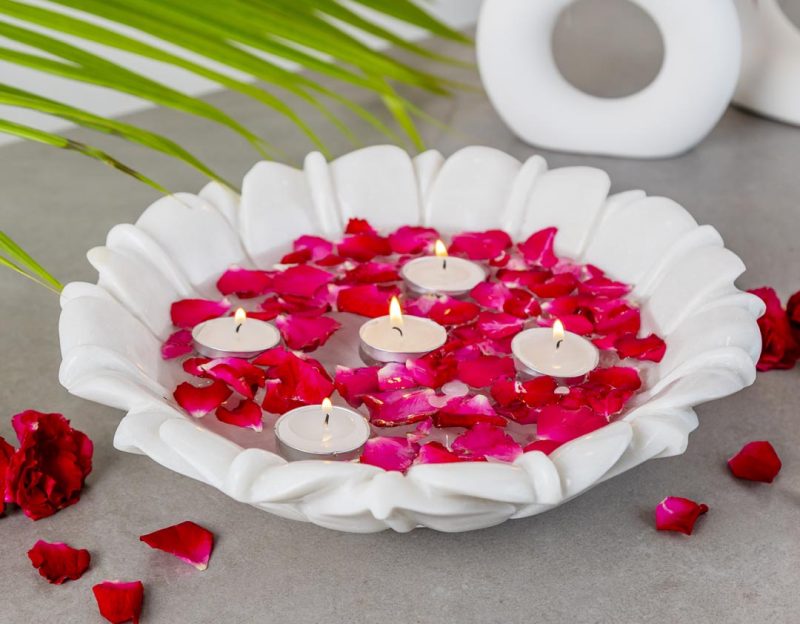 Natural Handicrafts' Calm Candle Floater with delicate flower design, adorned with vibrant rose petals and lit tea candles, creating a peaceful and romantic atmosphere.