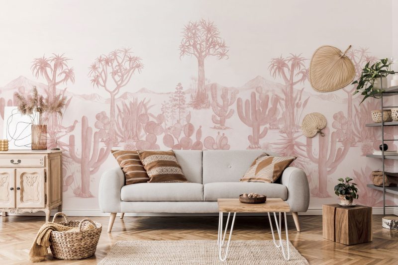 Wallpaper with a 'Desert Pink' theme, showcasing a variety of cacti and desert trees in soft hues, complementing the minimalist and natural decor of the room.