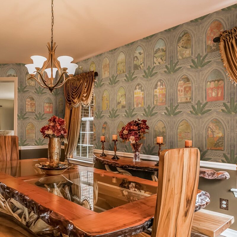 Opulent dining room adorned with Ramayan Jharokha Antique painting wallpaper, depicting scenes from the epic in a jharokha style, enhancing the room's cultural and aesthetic appeal.